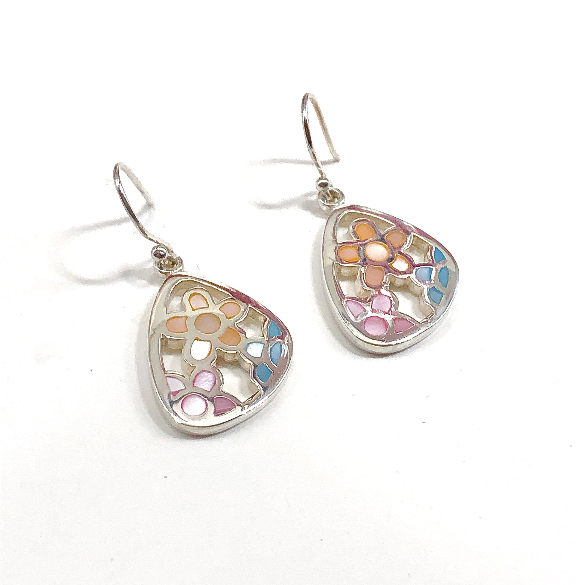 Teardrop-shaped earrings with floral pattern on a white background