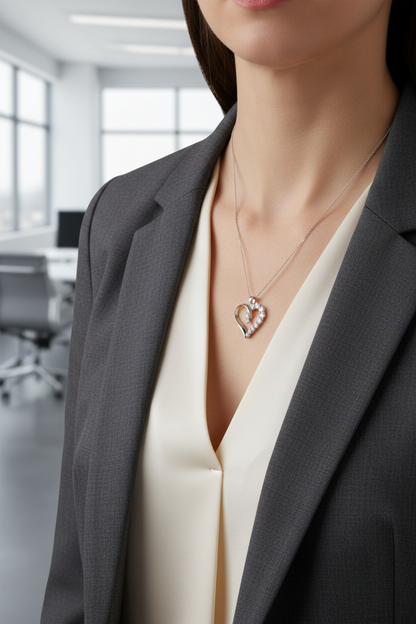 Person wearing a heart-shaped necklace in an office setting