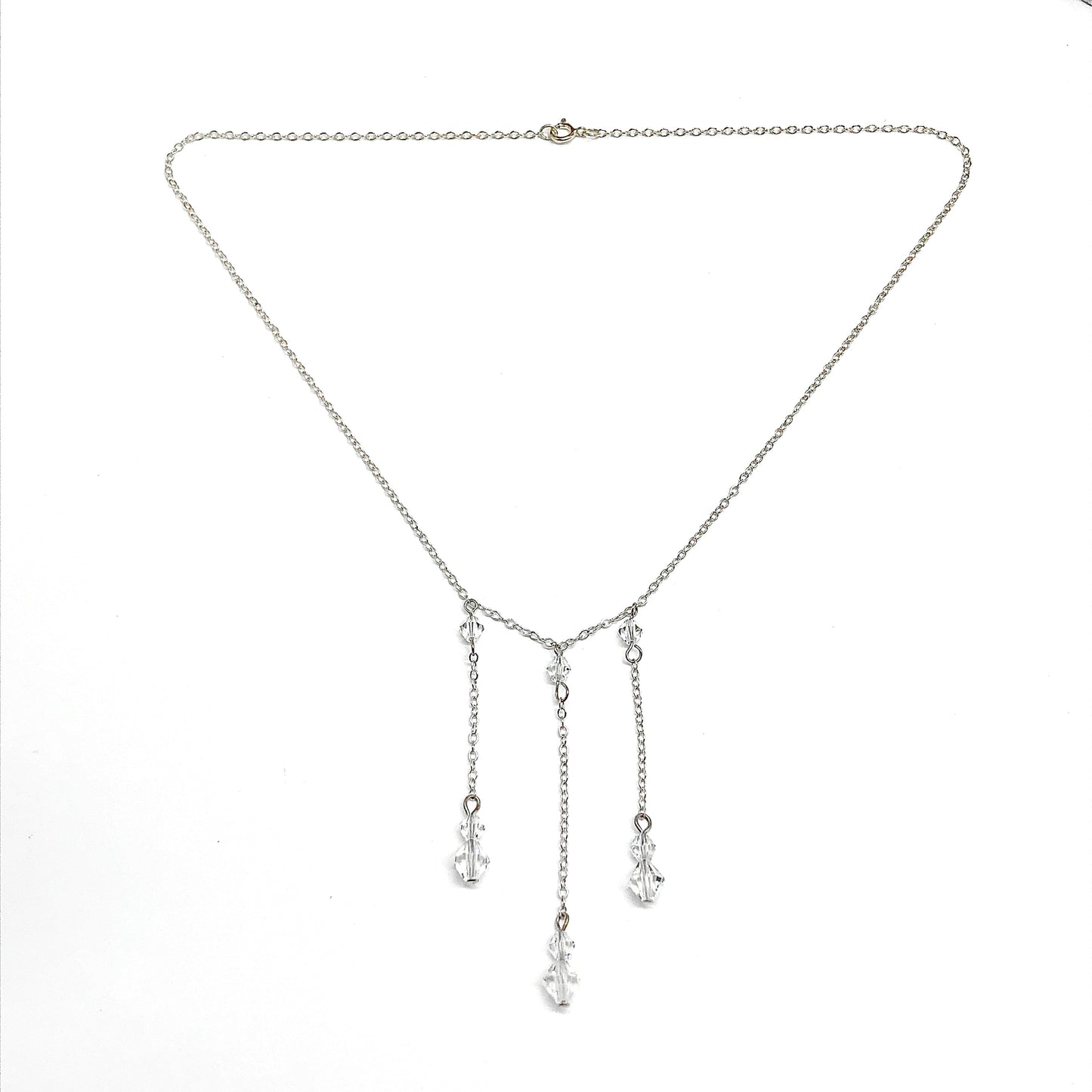Silver necklace with dangling cryatal bead charms on a white background