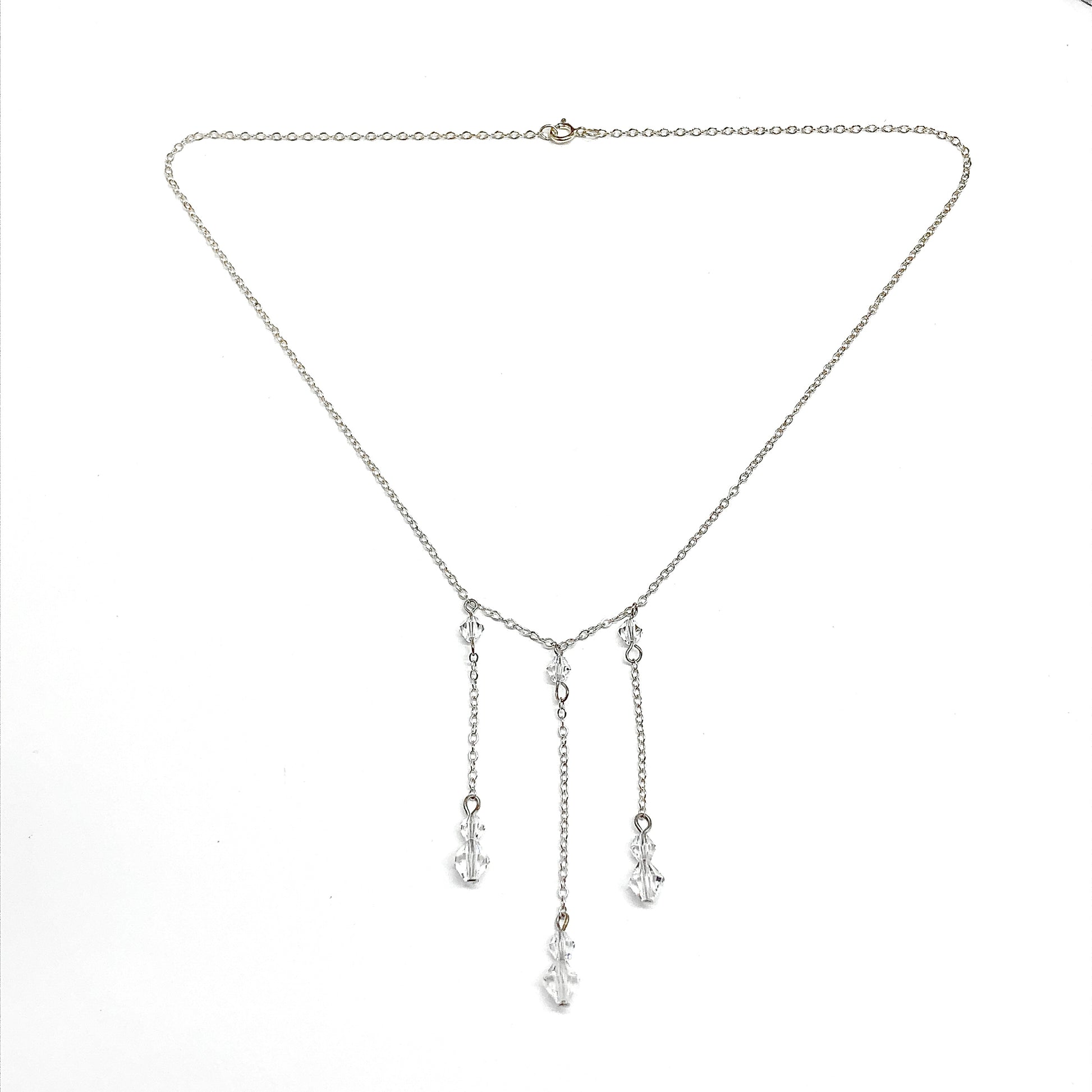 Silver necklace with dangling cryatal bead charms on a white background