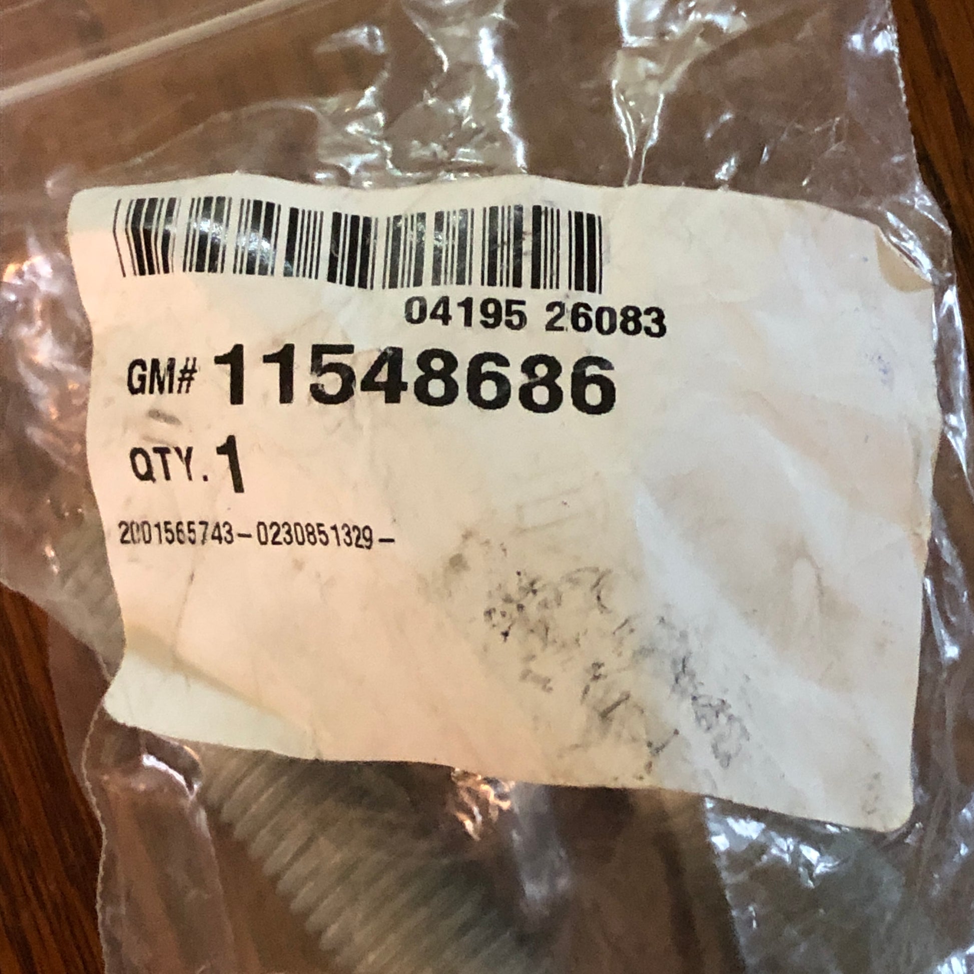 GM industrial Crankshaft Balancer Bolt. This OEM component is inside a clear plastic bag with a white paper label showing a barcode and part number 11548686.