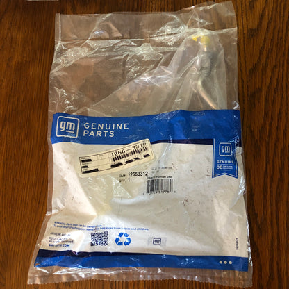An authentic GM Genuine Parts plastic bag containing an authentic GM automotive replacement part number 12663312 for GMC Chevy Truck Fuel Feed Line.