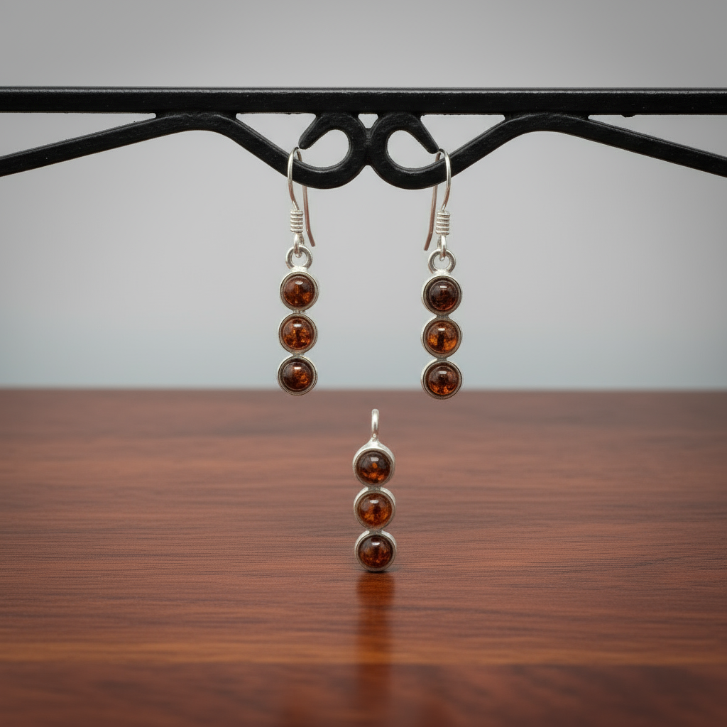 Pair of 925 sterling silver earrings with amber gemstones on a wooden surface.