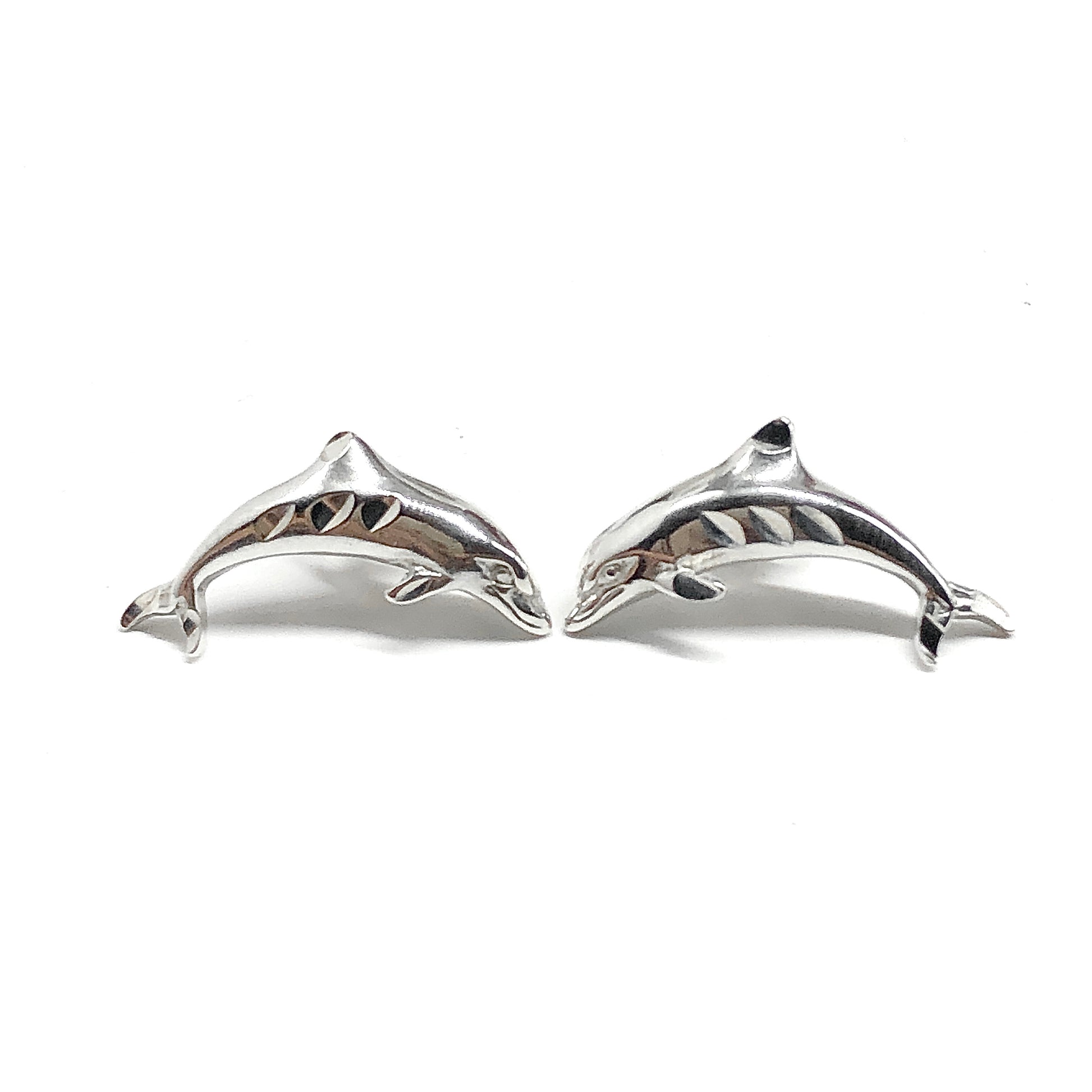 Pair of sterling silver dolphin earrings on a white background