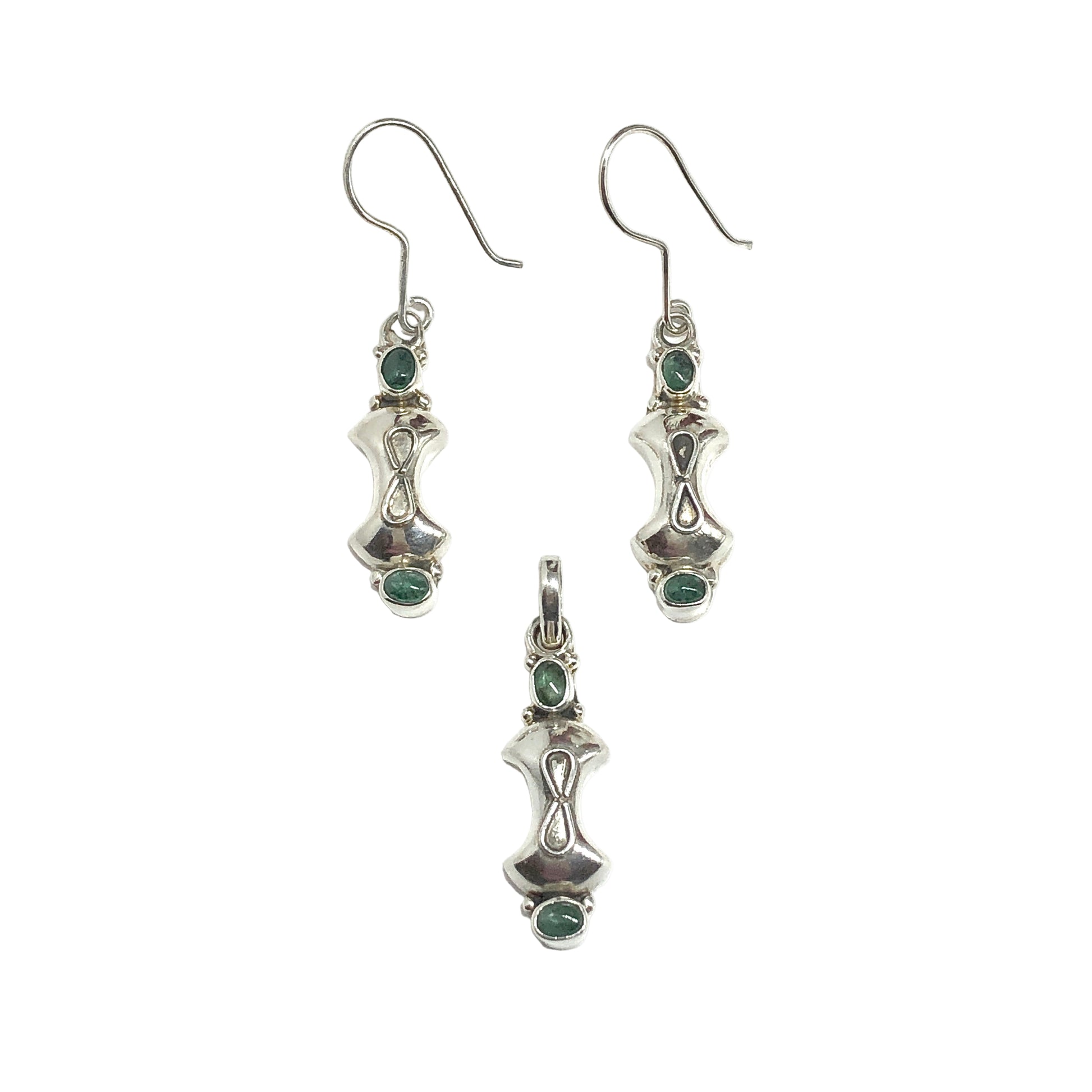 Silver earrings and pendant with green gemstones on a white background