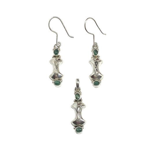 Silver earrings and pendant with green gemstones on a white background