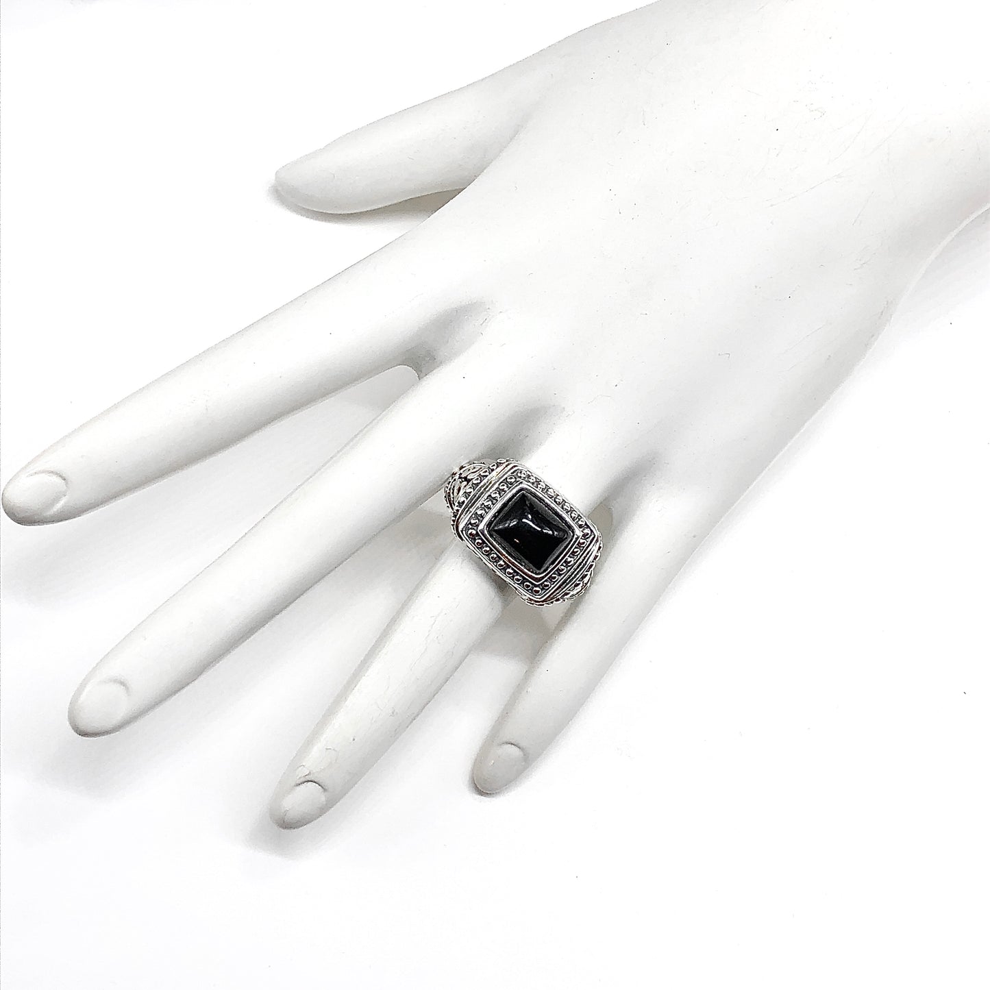 925 Silver ring bold rectangle style with a black gemstone on a white mannequin hand