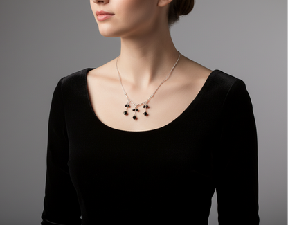 Woman wearing a black dress with a black beaded sterling silver necklace