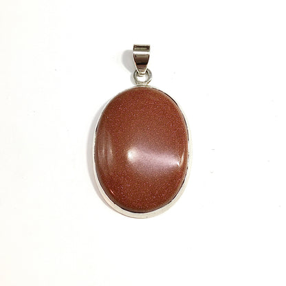 An oval pendant featuring a polished, metallic bronze-colored stone in a sleek oval sterling silver bezel setting, complete with a plain  925 silver bail.