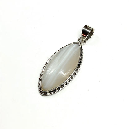 A sterling silver pendant featuring a large, polished marquise-shaped stone with subtle gray, tan and white bands, set in a rope textured 925 silver bezel with a large sized bail at the top.