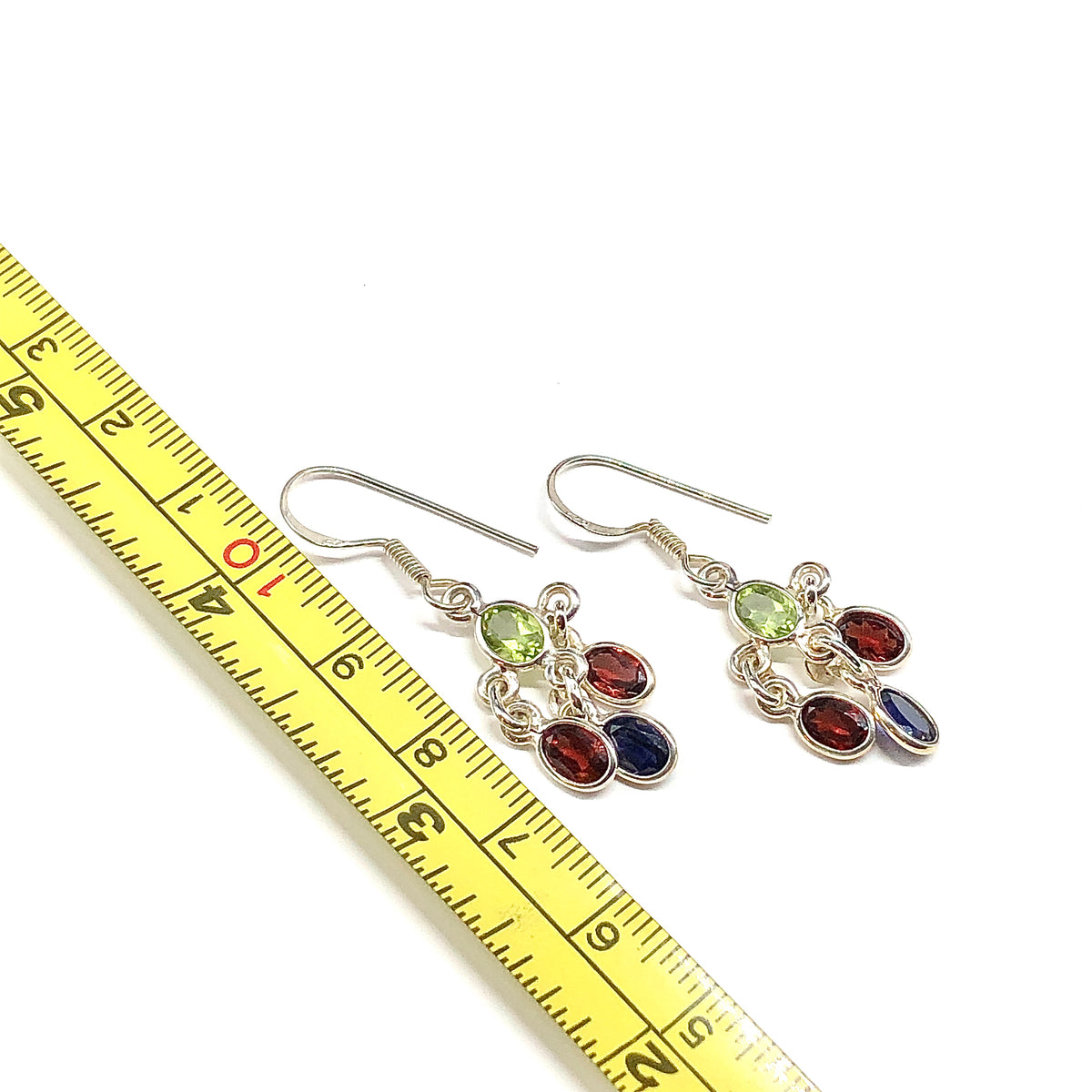 A pair of 925 sterling silver dangle earrings with green, red, and purple gemstones.